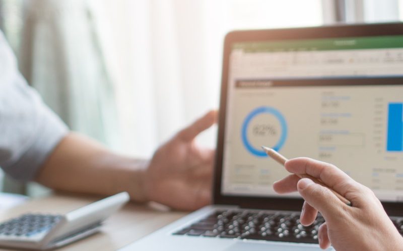 Weekly team meeting in the conference room. Close up view of business people in project pointing to laptop screen and  discussing budget financial for new project in meeting in workplace.